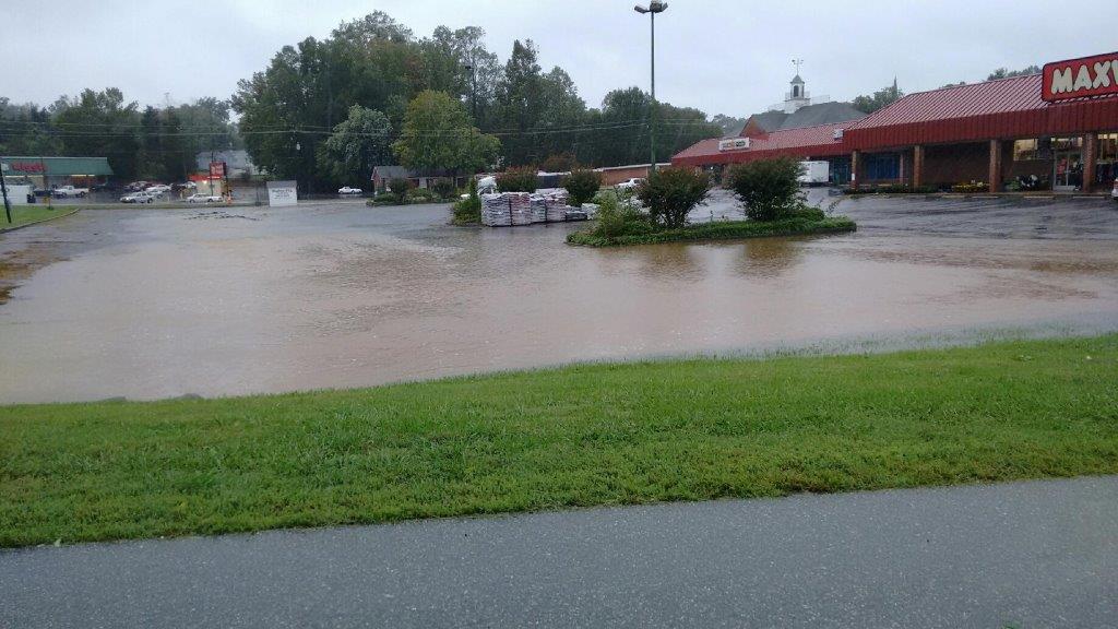 Large amounts of stormwater flooding a parking lot.